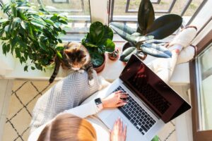 Remote worker working on her laptop and asking for what she needs as a remote employee